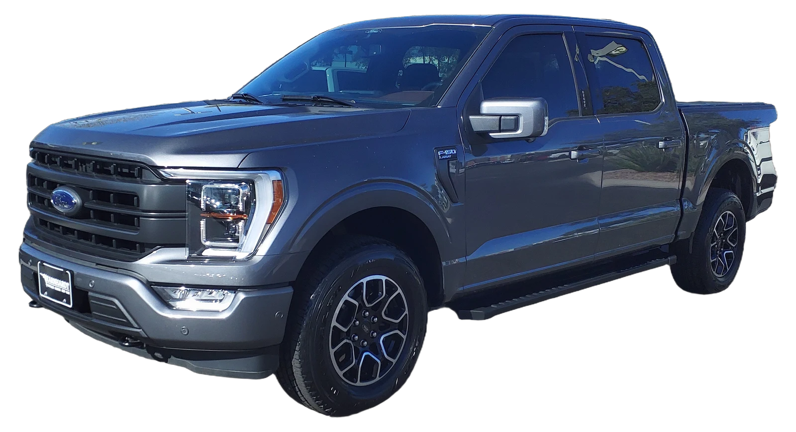 A grey 2021 Ford F-150 Lariat SuperCrew, photographed from the front three-quarter, cut out on a transparent background.